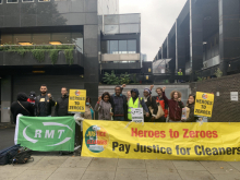 Photograph of an RMT cleaners' picket line at Euston; a large banner reads "Pay Justice for Cleaners"