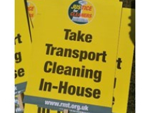 Yellow placards reading "Take Transport Cleaning In-House", with an RMT "Justice for Cleaners" logo