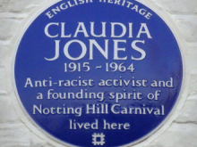 A blue English Heritage plaque reading: Claudia Jones 1915-1964 Anti-racist activist and founding spirit of Notting Hill Carnival lived here
