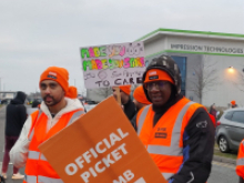 Pickets at Amazon facility carrying placards