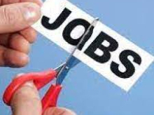 Fingers holding scissors cutting the word "Jobs", representing job cuts
