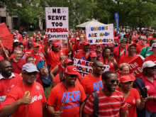 A large crowd of union member in red t-shirts protest the Trump government's sackings of public sector workers