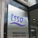 Metal sign outside the former TSSA headquarters reading "tssa – the union for people in transport and travel," with the address "Walkden House, 10 Melton Street." A glass entrance door is visible beside the sign.